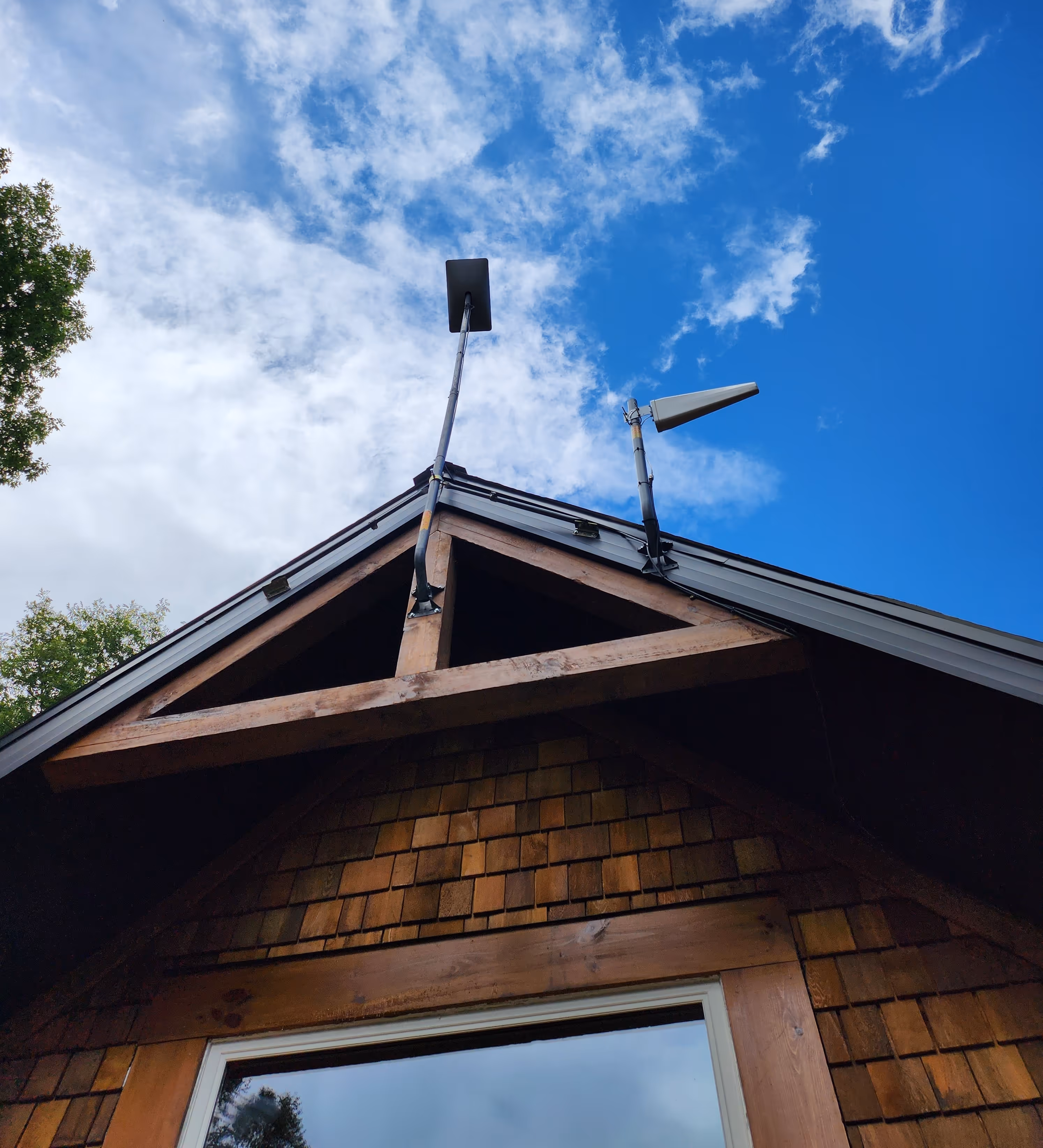 gen 2 starlink j-arm and cell extender attached to a cottage roof